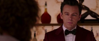 Movie still from “Passengers” (2016), directed by Morten Tyldum – A person wearing a suit and a bow tie; Close Up shot, Over the shoulder angle