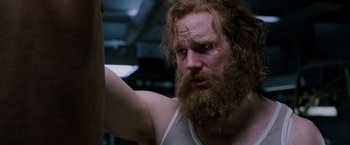 Movie still from “Passengers” (2016), directed by Morten Tyldum – A man with red hair and a long beard; Close Up shot, Over the shoulder angle