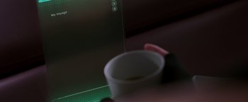 Movie still from “Passengers” (2016), directed by Morten Tyldum – A coffee cup sitting on top of a table; Extreme Close Up shot, Over the shoulder angle