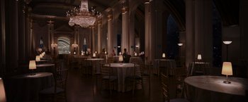 Movie still from “Passengers” (2016), directed by Morten Tyldum – People are sitting at tables in a large room; Extreme Wide shot, High angle