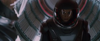 Movie still from “Passengers” (2016), directed by Morten Tyldum – A woman in a spacesuit is looking at the camera; Close Up shot, Low angle
