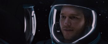 Movie still from “Passengers” (2016), directed by Morten Tyldum – A person wearing a space helmet; Close Up shot, Over the shoulder angle