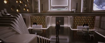 Movie still from “Passengers” (2016), directed by Morten Tyldum – A man in a suit standing in an empty room; Extreme Wide shot, High angle