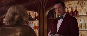 Movie still from “Passengers” (2016), directed by Morten Tyldum – A man in a red jacket is holding a knife; Medium shot, Over the shoulder angle