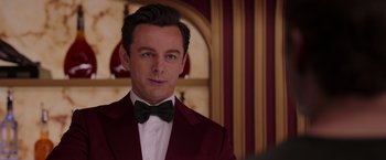 Movie still from “Passengers” (2016), directed by Morten Tyldum – A person wearing a suit and bow tie; Close Up shot, Over the shoulder angle