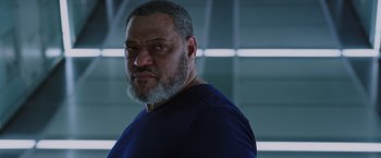 Movie still from “Passengers” (2016), directed by Morten Tyldum – A man with a beard and a blue t - shirt; Close Up shot, Low angle