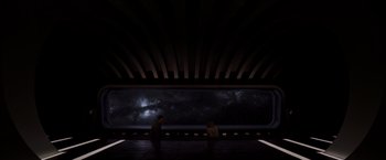 Movie still from “Passengers” (2016), directed by Morten Tyldum – Two people are standing in front of a large window; Extreme Wide shot, Low angle