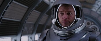 Movie still from “Passengers” (2016), directed by Morten Tyldum – A person wearing a space suit; Close Up shot, Over the shoulder angle