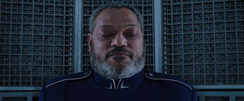 Movie still from “Passengers” (2016), directed by Morten Tyldum – An older man with a beard and a military uniform; Close Up shot, Overhead angle