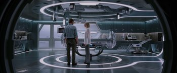 Movie still from “Passengers” (2016), directed by Morten Tyldum – A man and a woman standing in a room; Wide shot, Low angle