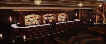Movie still from “Passengers” (2016), directed by Morten Tyldum – Two men standing at the bar of a restaurant; Extreme Wide shot, High angle