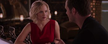 Movie still from “Passengers” (2016), directed by Morten Tyldum – A woman in a red dress talking to a man in a black shirt; Close Up shot, Over the shoulder angle