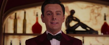 Movie still from “Passengers” (2016), directed by Morten Tyldum – A person wearing a suit and bow tie; Close Up shot, Low angle