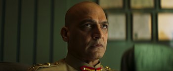 Movie still from “Pathaan” (2023), directed by Siddharth Anand – A person wearing a military uniform; Close Up shot, Low angle