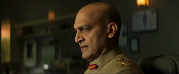 Movie still from “Pathaan” (2023), directed by Siddharth Anand – A man with a bald head wearing a military uniform; Close Up shot, Low angle