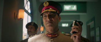 Movie still from “Pathaan” (2023), directed by Siddharth Anand – A person wearing a military uniform; Close Up shot, Low angle