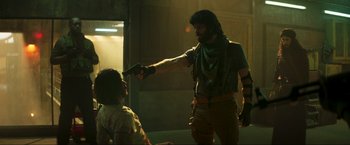 Movie still from “Pathaan” (2023), directed by Siddharth Anand – A man with a gun pointed at another man; Medium shot, Over the shoulder angle