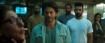 Movie still from “Pathaan” (2023), directed by Siddharth Anand – A group of men standing next to each other in a room; Medium shot, Low angle