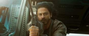 Movie still from “Pathaan” (2023), directed by Siddharth Anand – A person holding a gun; Close Up shot, Low angle