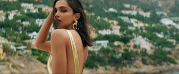 Movie still from “Pathaan” (2023), directed by Siddharth Anand – Deepika padukon is posing for a picture in front of a hillside; Close Up shot, Low angle
