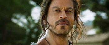 Movie still from “Pathaan” (2023), directed by Siddharth Anand – A person with long hair; Close Up shot, Over the shoulder angle