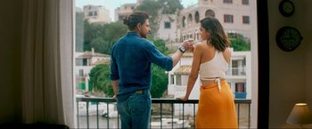 Movie still from “Pathaan” (2023), directed by Siddharth Anand – A man and a woman standing next to a railing; Medium shot, Low angle