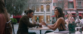 Movie still from “Pathaan” (2023), directed by Siddharth Anand – A man and a woman sitting at an outdoor table; Medium shot, Over the shoulder angle
