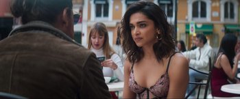 Movie still from “Pathaan” (2023), directed by Siddharth Anand – A woman sitting in front of two other women; Close Up shot, Over the shoulder angle