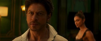 Movie still from “Pathaan” (2023), directed by Siddharth Anand – A person wearing a white shirt; Close Up shot, Low angle