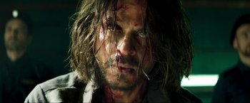 Movie still from “Pathaan” (2023), directed by Siddharth Anand – A person with blood all over his face; Extreme Close Up shot, Low angle