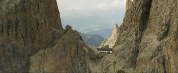 Movie still from “Pathaan” (2023), directed by Siddharth Anand – A building on the top of a mountain; Extreme Wide shot, High angle