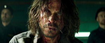 Movie still from “Pathaan” (2023), directed by Siddharth Anand – A person with blood all over his face; Close Up shot, Low angle