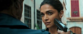 Movie still from “Pathaan” (2023), directed by Siddharth Anand – A person holding a hair brush; Close Up shot, Over the shoulder angle