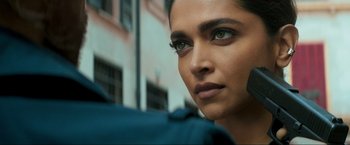 Movie still from “Pathaan” (2023), directed by Siddharth Anand – A woman's face in a city setting; Close Up shot, Over the shoulder angle