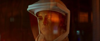 Movie still from “Pathaan” (2023), directed by Siddharth Anand – A woman wearing a helmet looking into a mirror; Close Up shot, Overhead angle