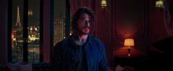 Movie still from “Pathaan” (2023), directed by Siddharth Anand – A man with long dark hair is looking up; Medium shot, Over the shoulder angle