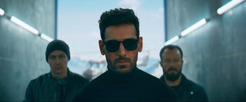 Movie still from “Pathaan” (2023), directed by Siddharth Anand – A person wearing sunglasses; Close Up shot, Low angle