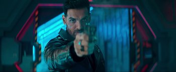 Movie still from “Pathaan” (2023), directed by Siddharth Anand – A person holding a gun; Close Up shot, Over the shoulder angle