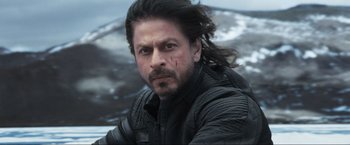 Movie still from “Pathaan” (2023), directed by Siddharth Anand – A person wearing a leather jacket; Close Up shot, Over the shoulder angle