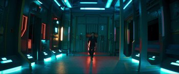 Movie still from “Pathaan” (2023), directed by Siddharth Anand – A man standing in a room with lights on the walls; Wide shot, Low angle