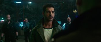 Movie still from “Pathaan” (2023), directed by Siddharth Anand – A person wearing a jacket; Close Up shot, Over the shoulder angle