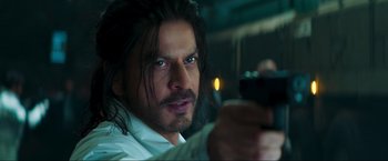 Movie still from “Pathaan” (2023), directed by Siddharth Anand – A person holding a gun; Close Up shot, Over the shoulder angle