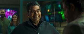 Movie still from “Pathaan” (2023), directed by Siddharth Anand – A person smiling for the camera; Close Up shot, Over the shoulder angle