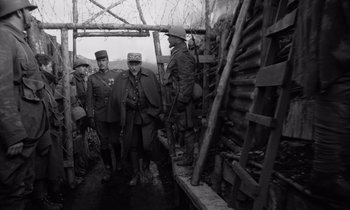 Movie still from “Paths of Glory” (1957), directed by Stanley Kubrick – A black and white photo of men in uniforms; Wide shot, Low angle