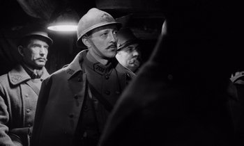 Movie still from “Paths of Glory” (1957), directed by Stanley Kubrick – A man in a military uniform and a man in a hat; Close Up shot, Low angle