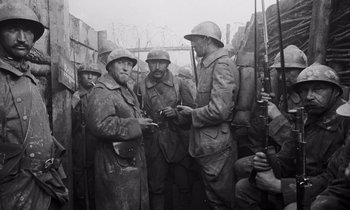 Movie still from “Paths of Glory” (1957), directed by Stanley Kubrick – A black and white photo of men in trench coats and helmets; Medium shot, High angle