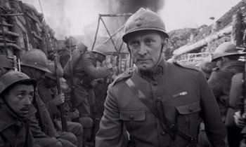 Movie still from “Paths of Glory” (1957), directed by Stanley Kubrick – An old photo of a man in a military uniform; Close Up shot, Low angle