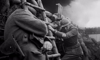 Movie still from “Paths of Glory” (1957), directed by Stanley Kubrick – An old black and white photo of a man with a rifle; Medium shot, Low angle