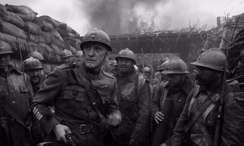 Movie still from “Paths of Glory” (1957), directed by Stanley Kubrick – A black and white photo of a group of soldiers; Medium shot, Low angle