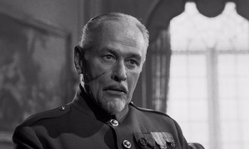 Movie still from “Paths of Glory” (1957), directed by Stanley Kubrick – An older man in a military uniform looking at the camera; Close Up shot, Low angle